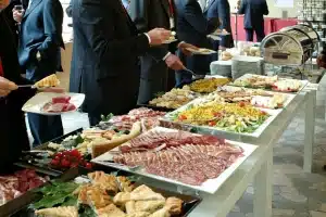 corporate buffet with people helping themselves