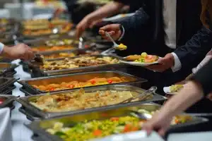 people plating up at a buffet