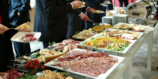 corporate buffet with people helping themselves