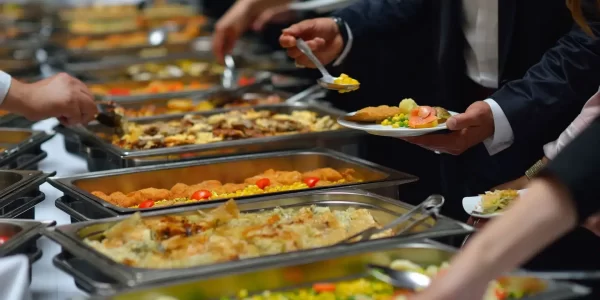 people plating up at a buffet